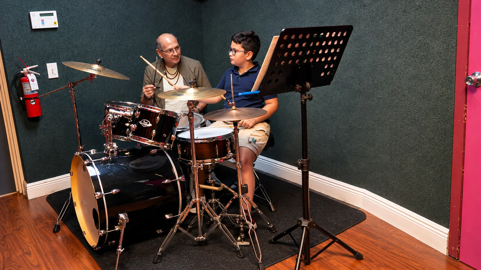 Teacher coaching a drum student