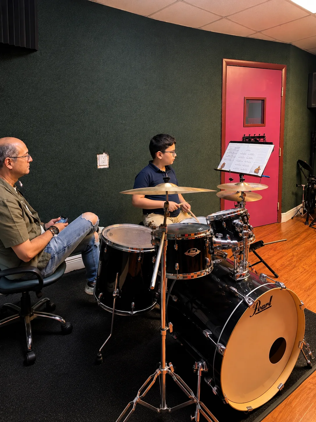 Drum student practicing with his teacher