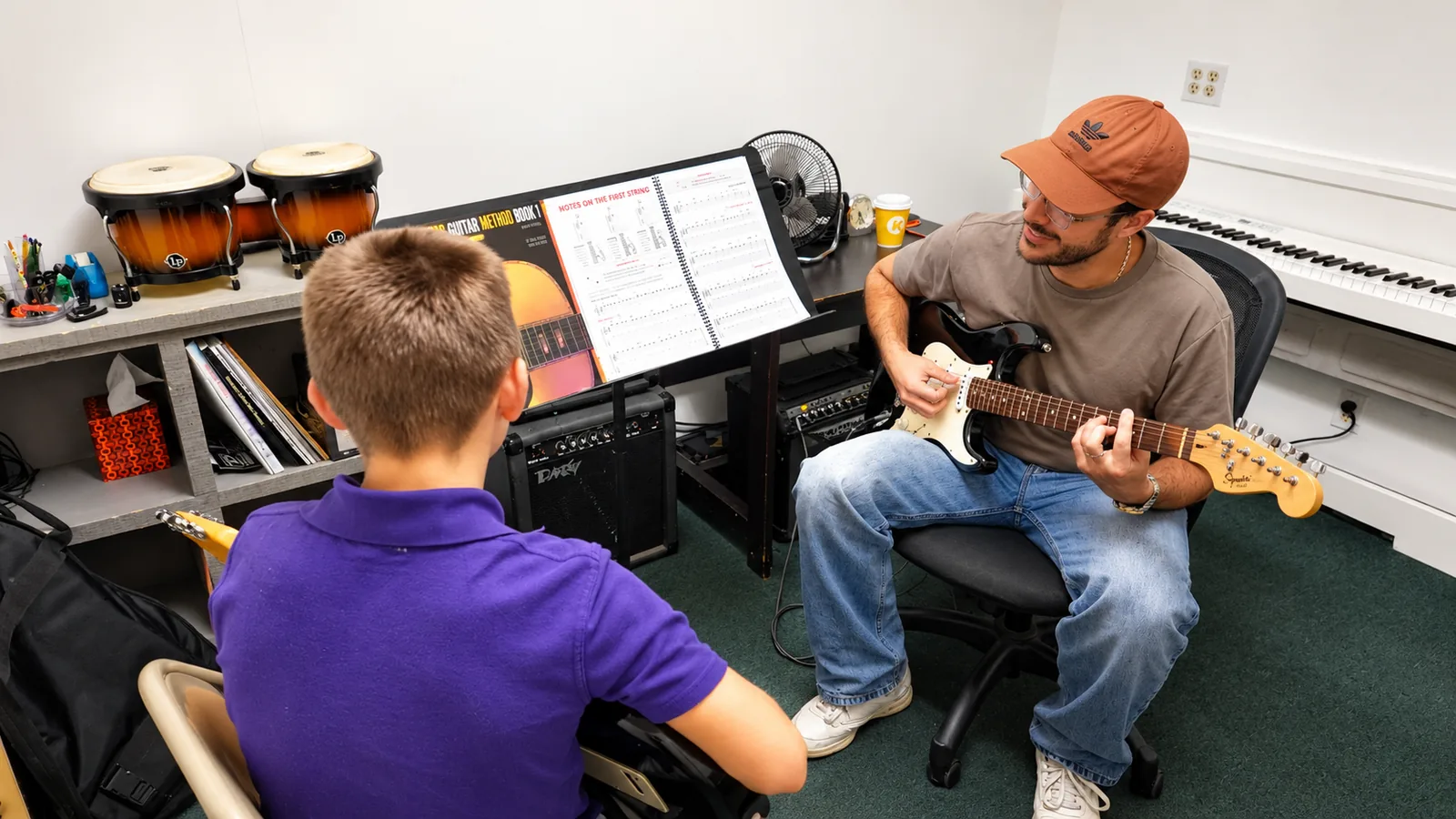 Teacher and student making music at PRO MUSIC+