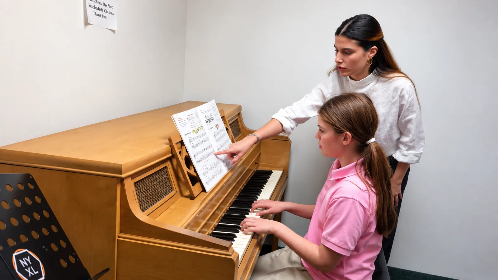 Piano student and teacher sharing a lesson