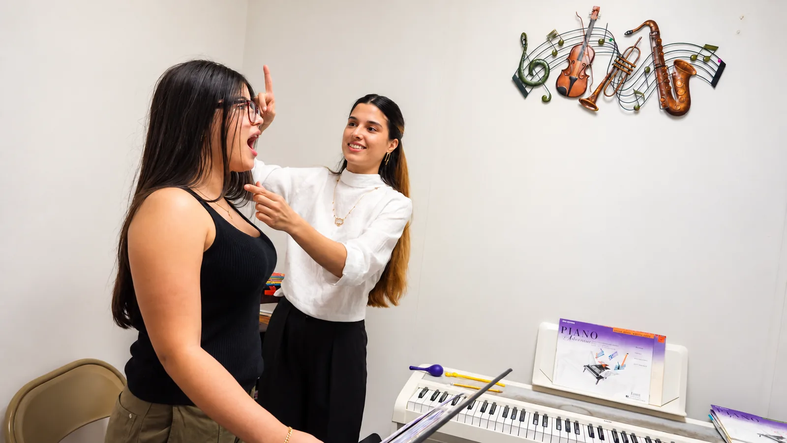 Teacher guiding a student through a music lesson